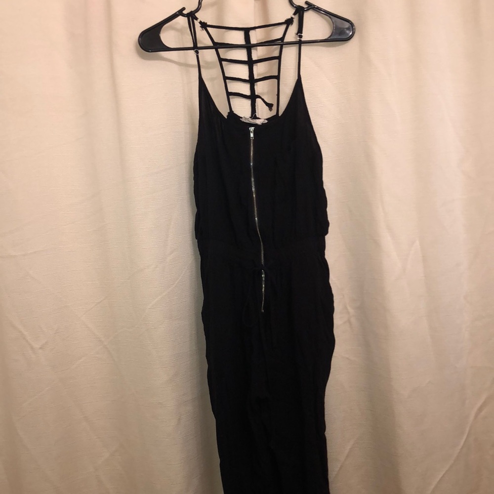Black romper with front zipper and tie string.